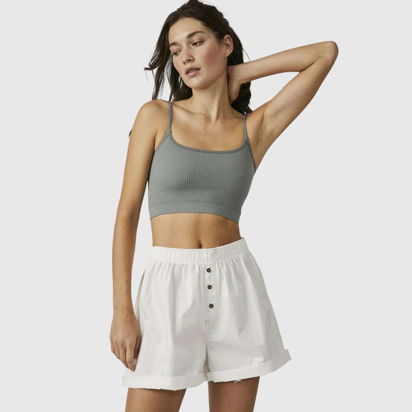 Plum Bottom model wearing a sage green ribbed brami and white button-front shorts against a neutral background