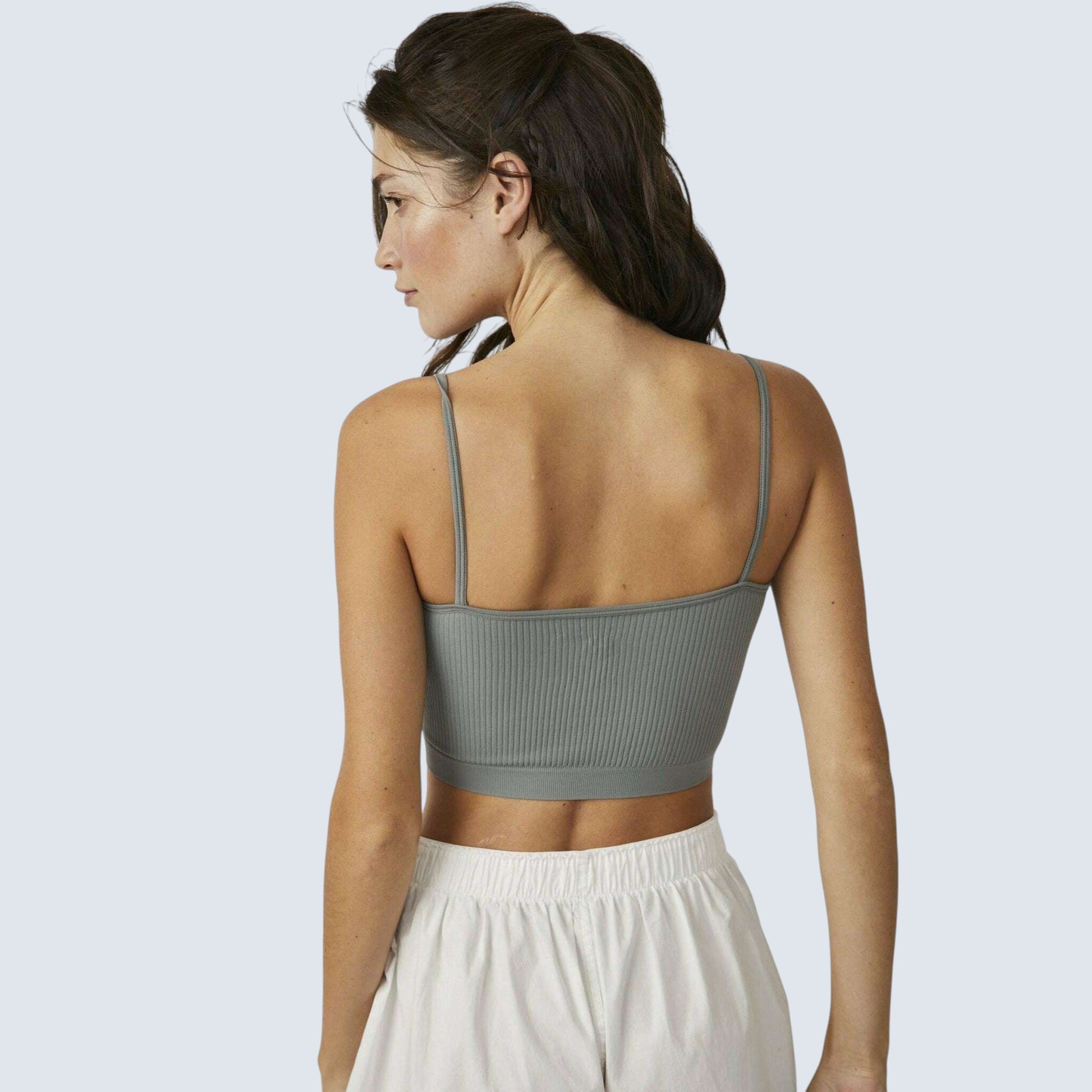 Plum Bottom model wearing a sage green ribbed cropped brami with thin straps, back view