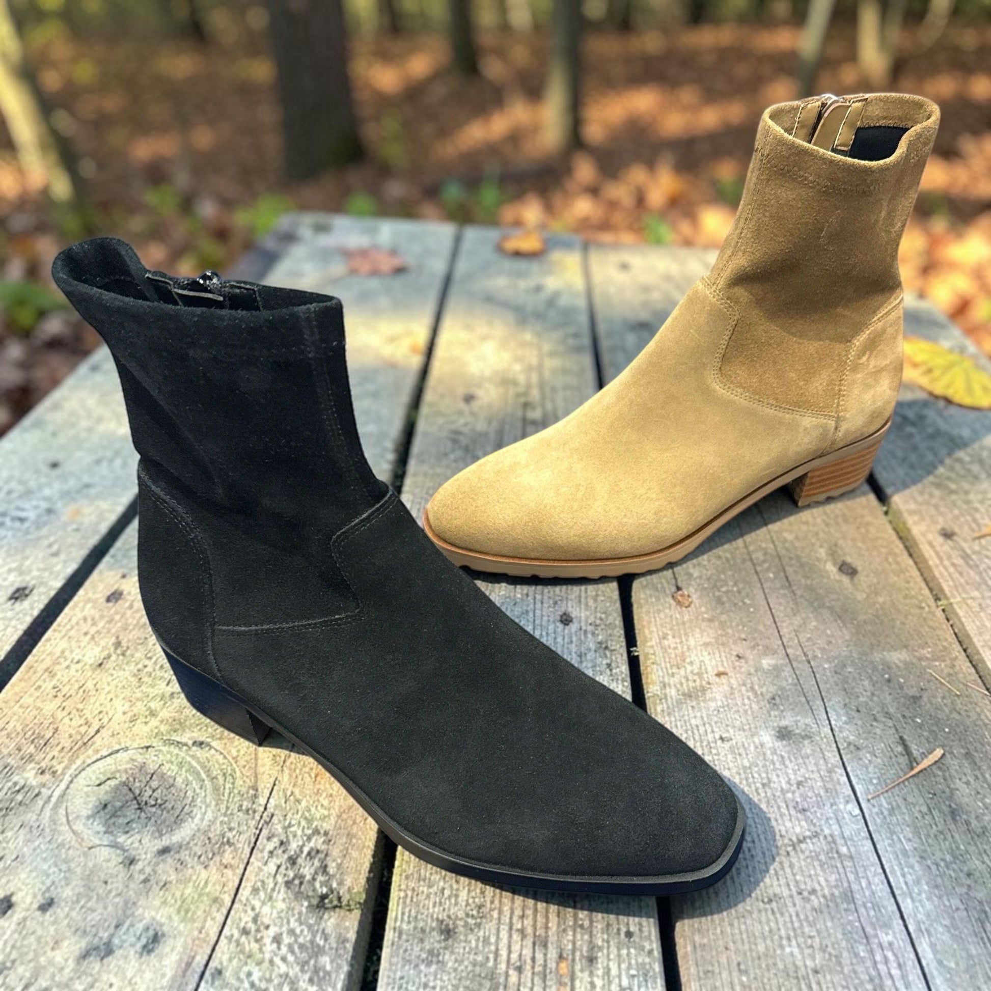 Plum Bottom VANELI Oleg suede booties in black and tan with low block heels and side zippers.