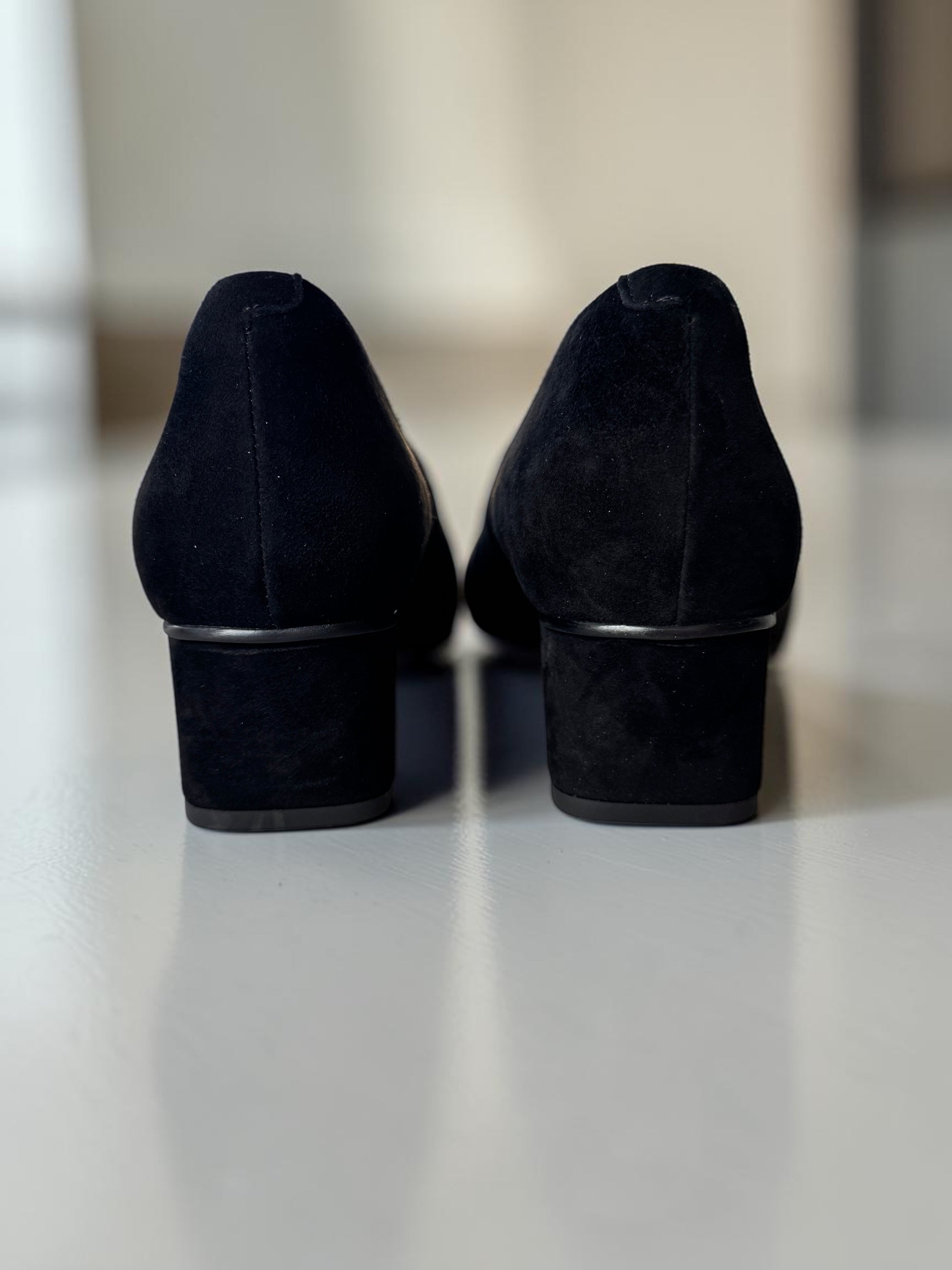 Plum Bottom VANELI Solara black suede block heel pumps viewed from the back showing the refined silhouette