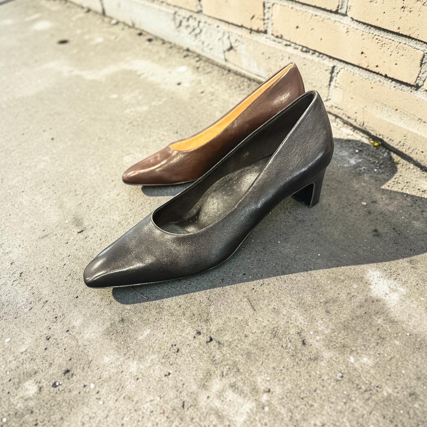 Plum Bottom VANELI Windy leather pumps in black and brown, featuring a pointed toe and a modest block heel.
