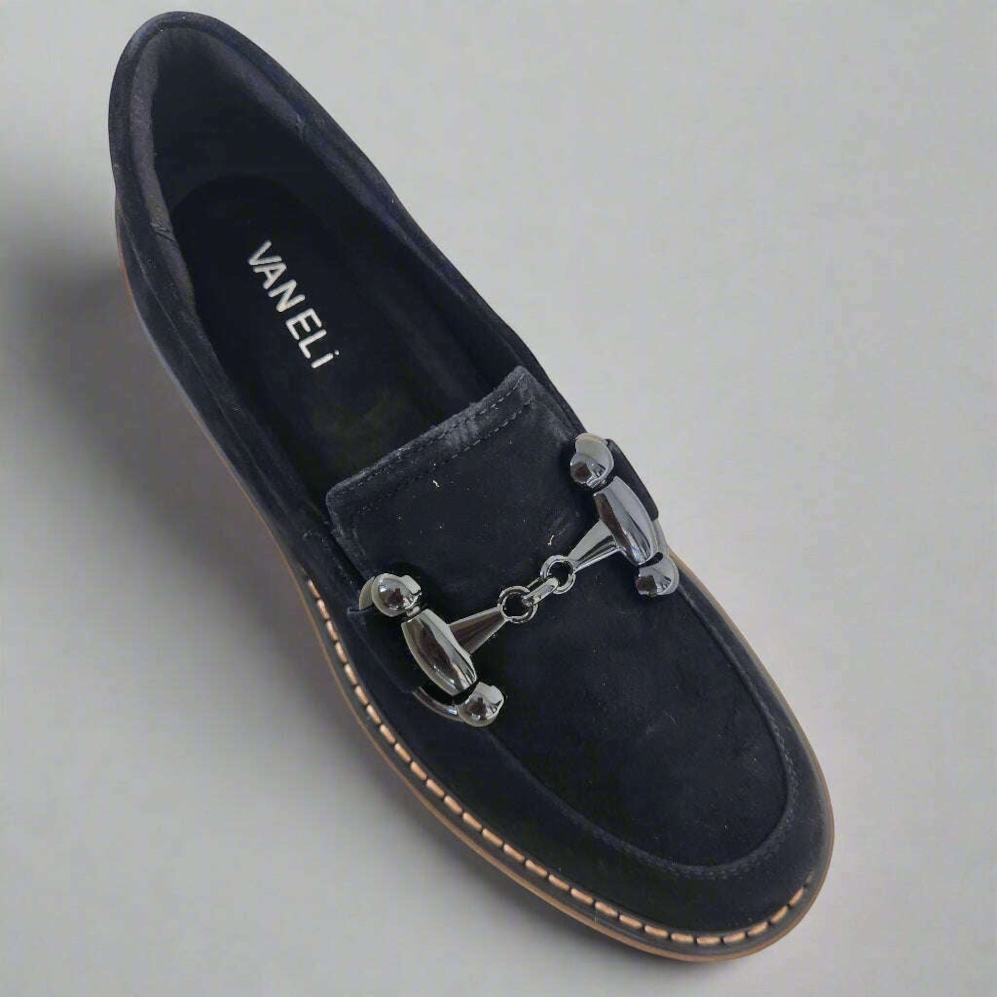 Plum Bottom VANELI Zimmy black suede loafer with a shiny metal bit, lug sole, and contrasting tan welt stitching.