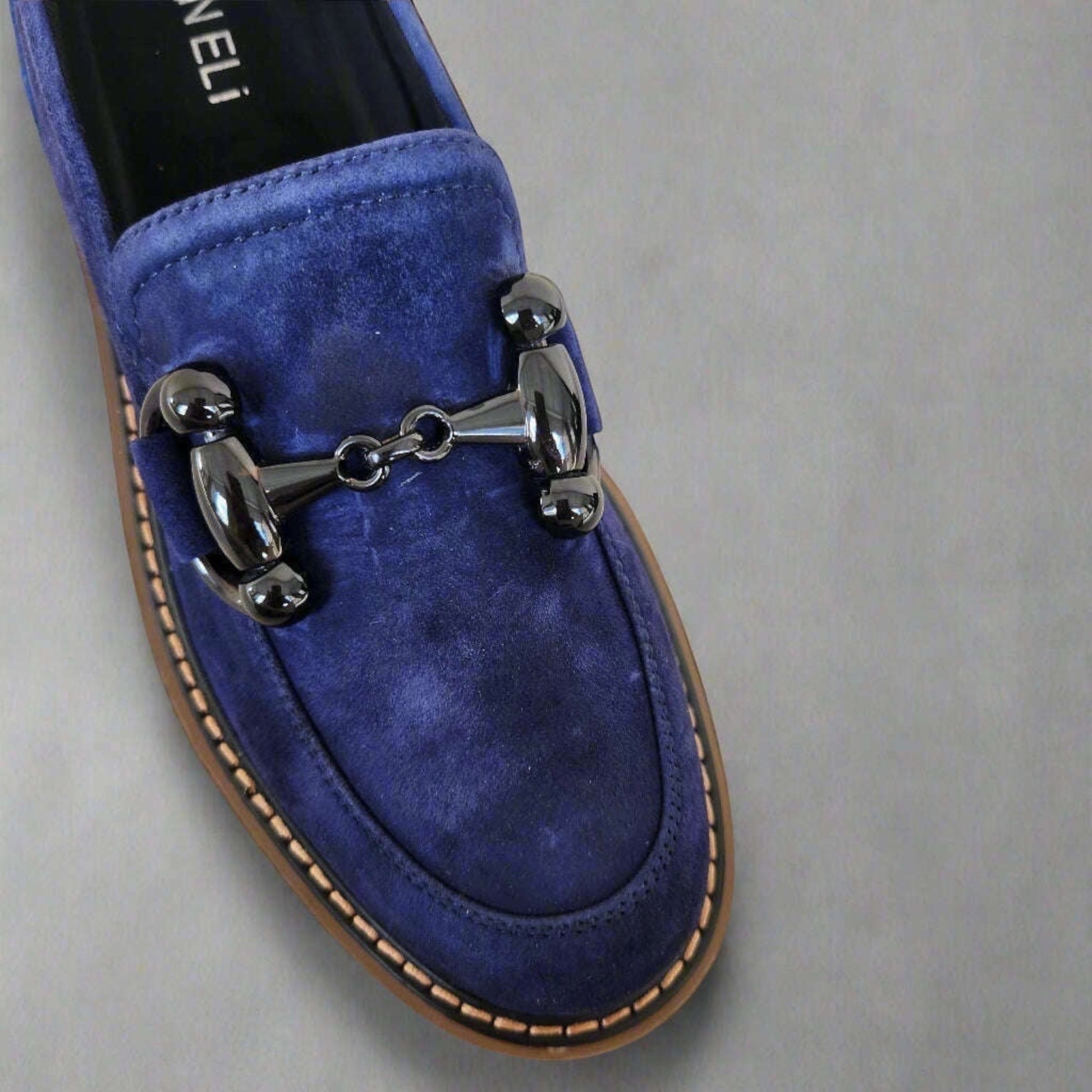 Plum Bottom VANELI Zimmy blue suede loafer with a shiny metal bit, lug sole, and contrasting tan welt stitching.