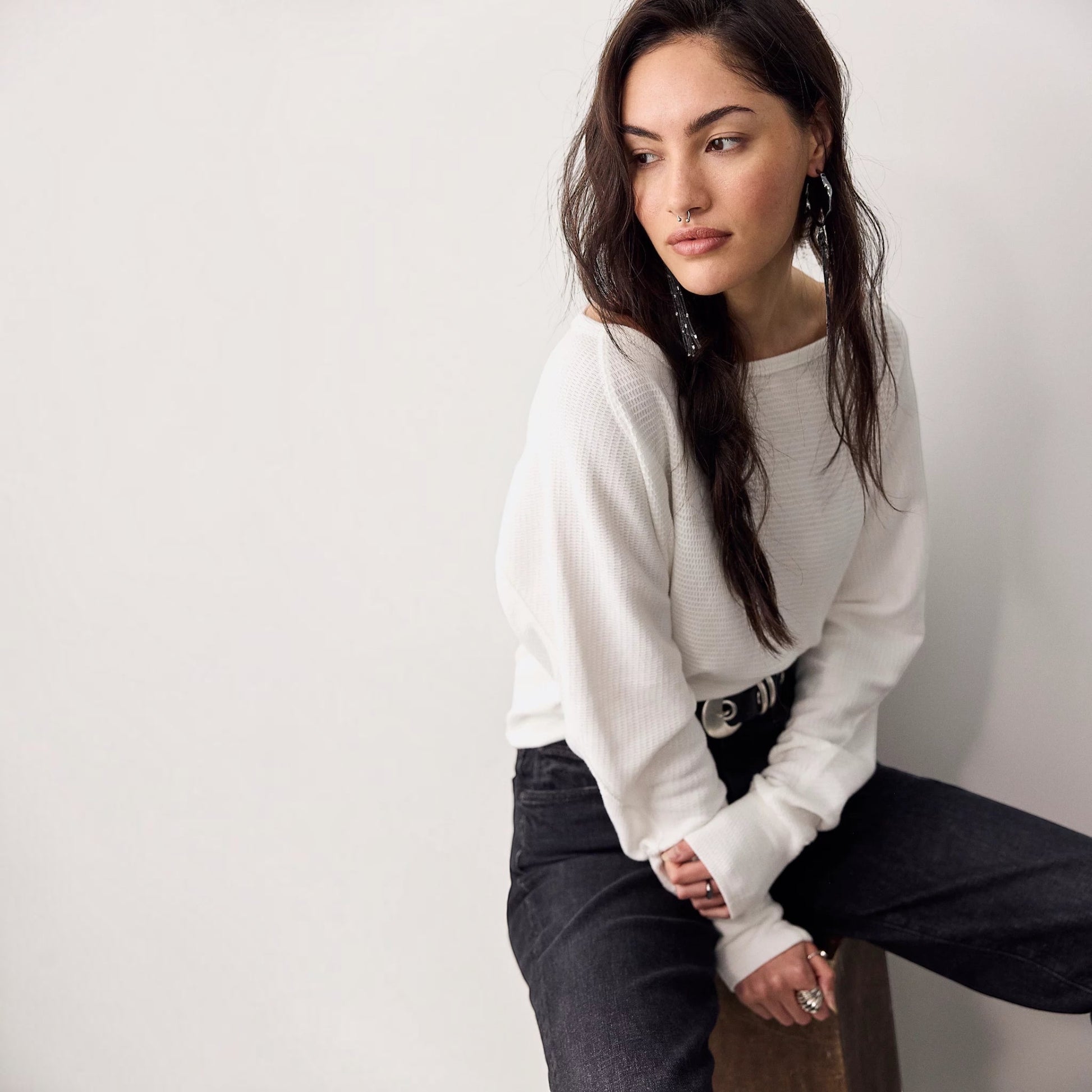 Plum Bottom model wearing a white Free People Jess long sleeve thermal top with a boat neckline and dolman sleeves.