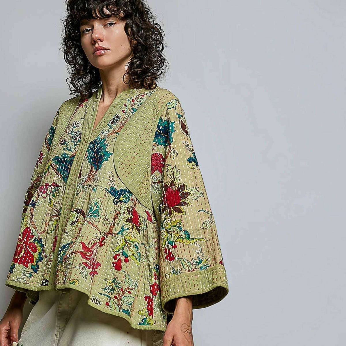 Plum Bottom Pol Clothing quilted floral kimono top in powder olive with hand-stitch detail and wide sleeves.