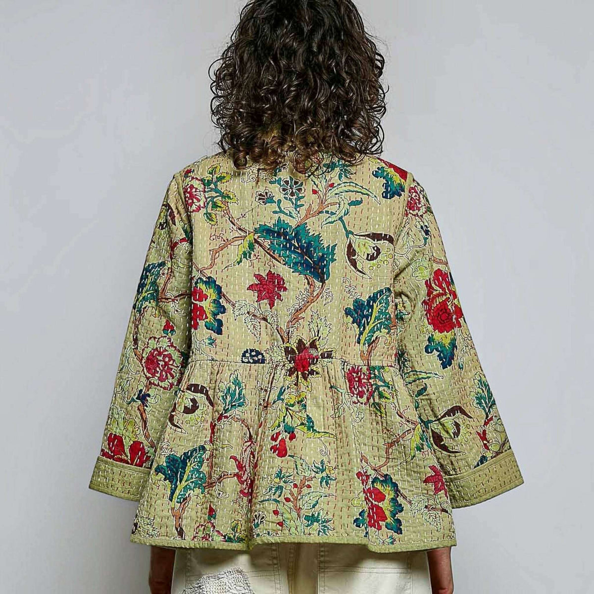Plum Bottom quilted floral kimono-style top in powder olive with contrast hand-stitch detailing and wide sleeves.