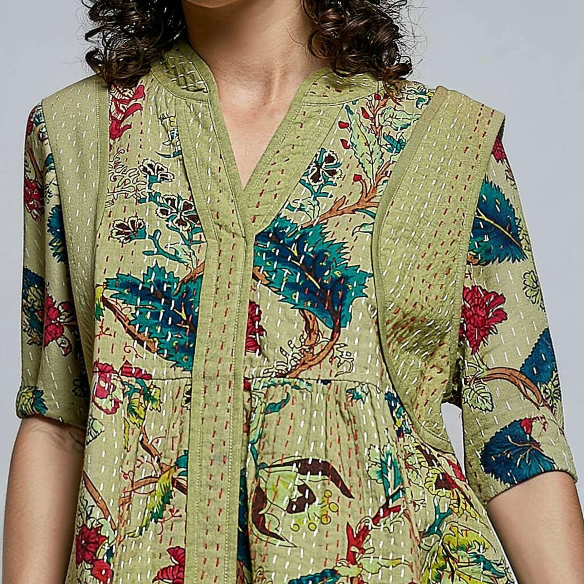 Plum Bottom Pol Clothing quilted floral kimono-style top in powder olive with contrast hand-stitch detailing.