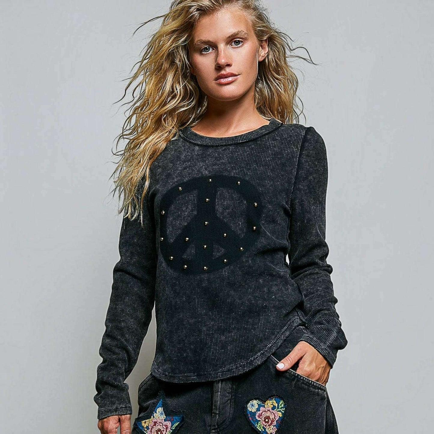 Plum Bottom thermal knit top with vintage wash, peace sign stud detail, and outseam stitching on a blonde model.