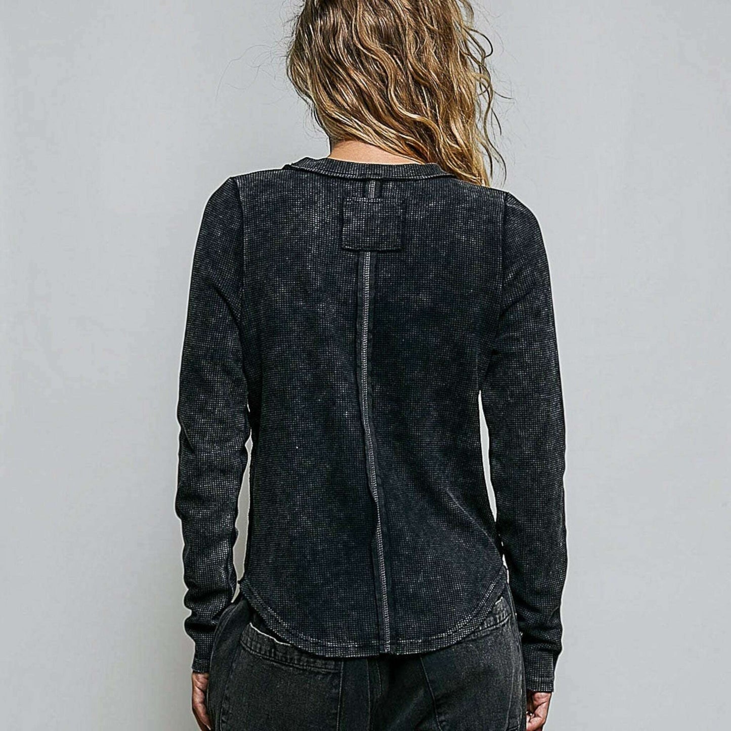 Plum Bottom POL CLOTHING black thermal knit top with vintage wash, outseam detailing, and overlock stitch back view