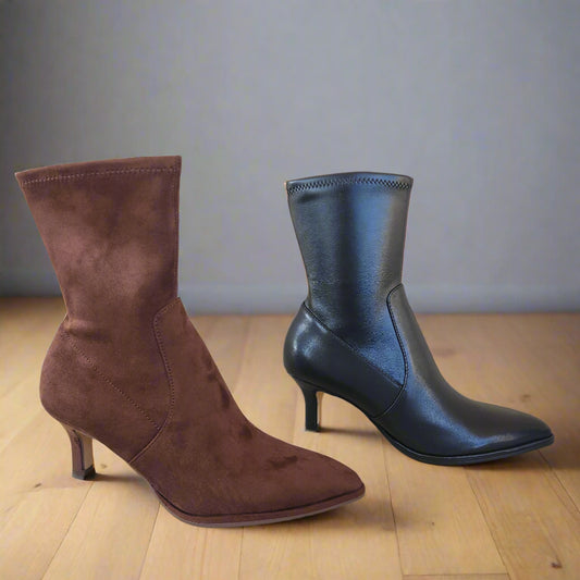 Black and brown high-heeled boots on a tiled floor