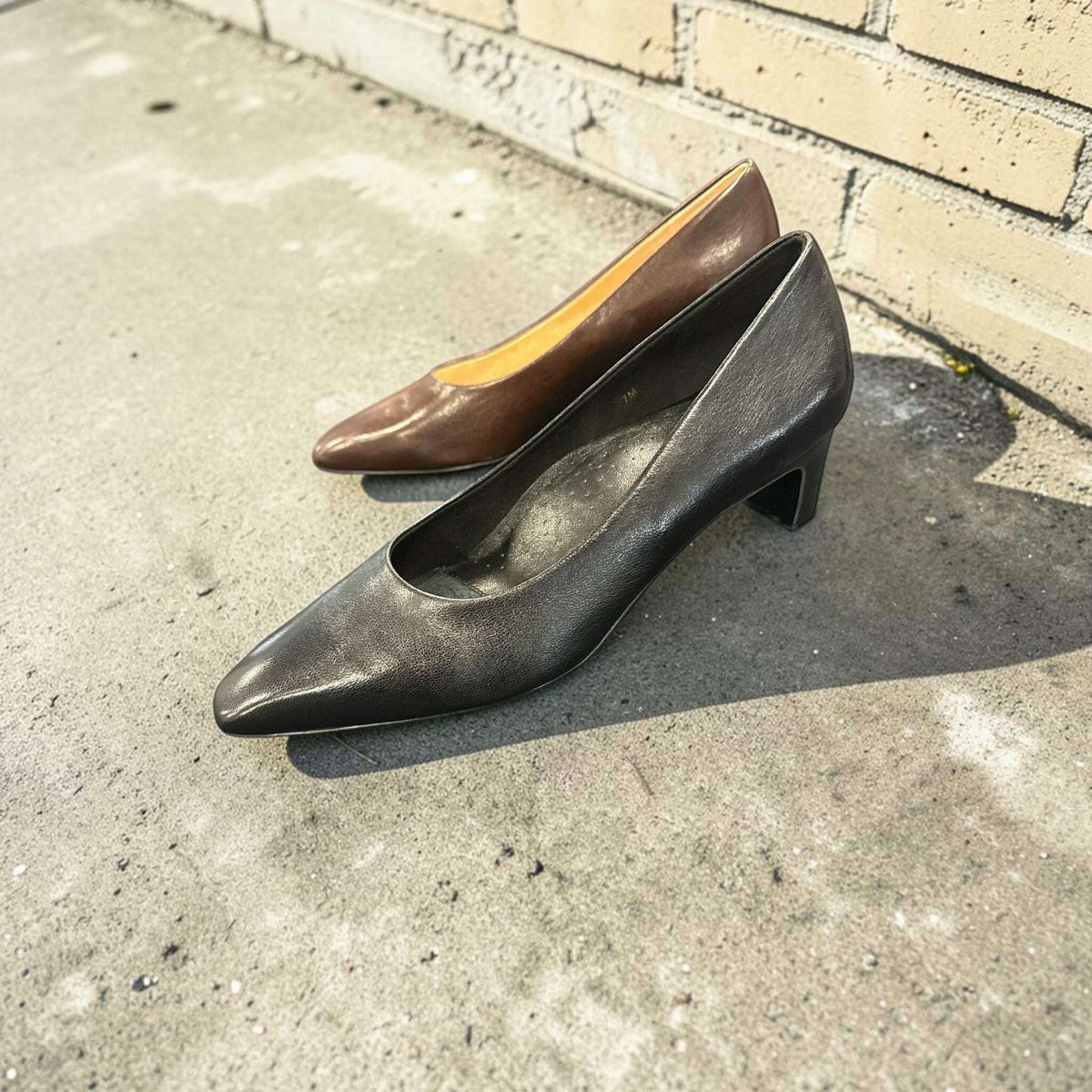 Plum Bottom VANELI Windy leather pumps in black and brown, featuring a pointed toe and a modest block heel.