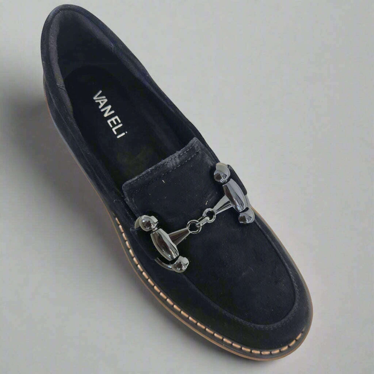 Plum Bottom VANELI Zimmy black suede loafer with a shiny metal bit, lug sole, and contrasting tan welt stitching.